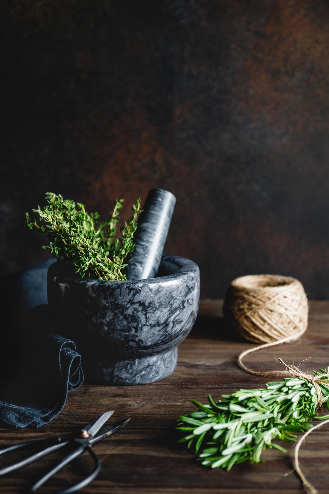 small test kitchen with stainless tools and herbs